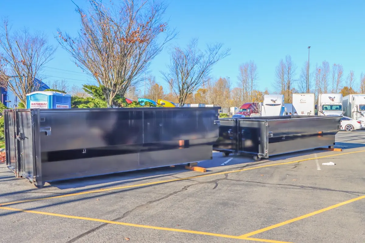 Professional dumpster rental service with roll-off container on residential driveway in Cameron Park